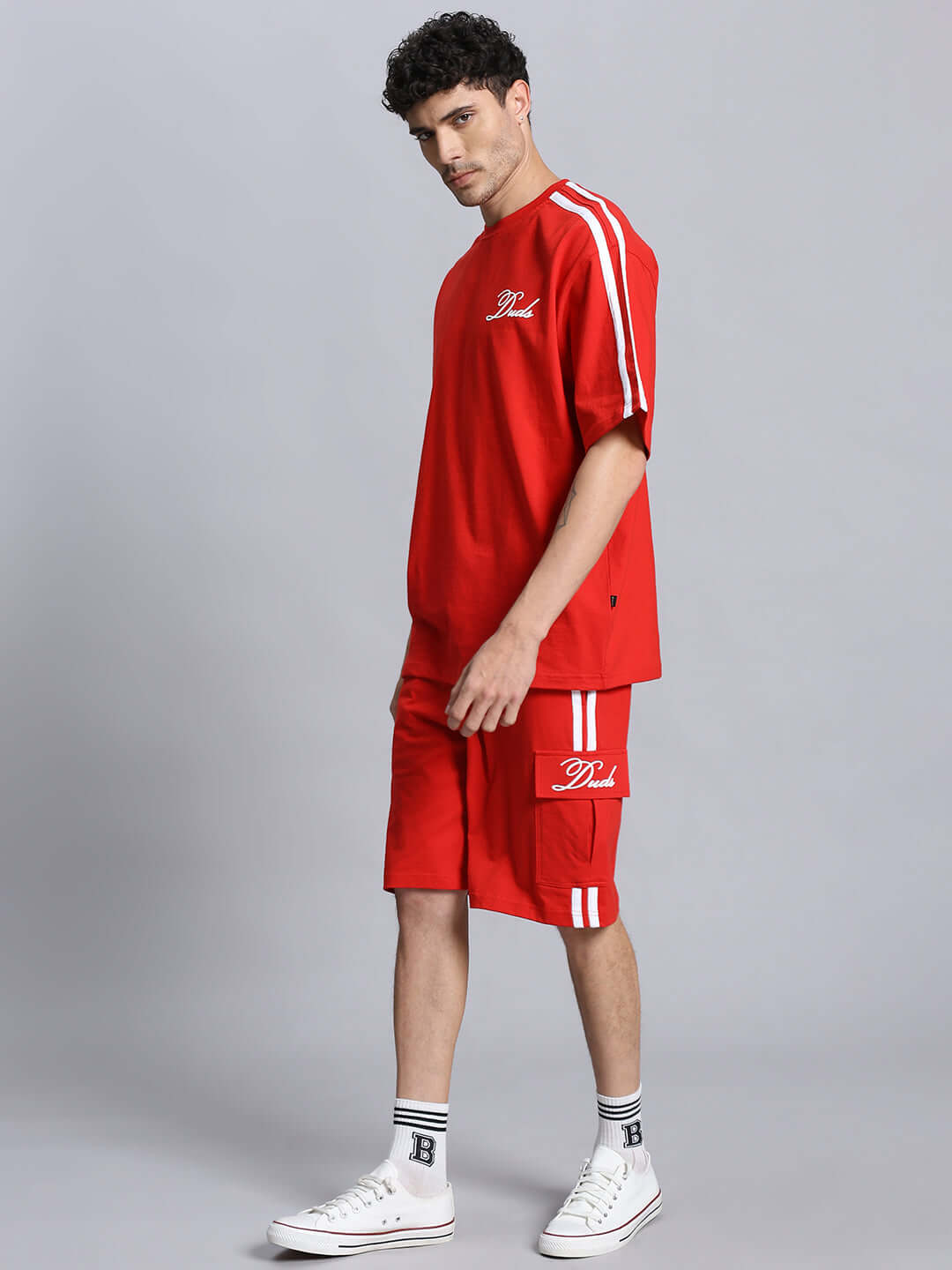 Man wearing the Scotia Summer Co-ord Set in red, featuring premium cotton fabric and athletic stripes; stylish and comfortable fit.