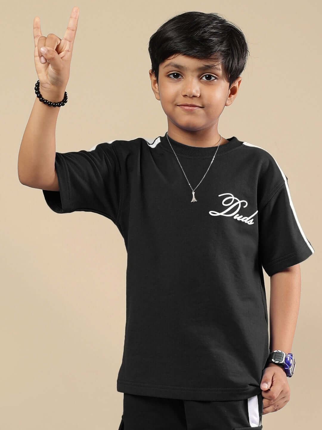 Child wearing SCOTIA T-SHIRT FOR BOYS & GIRLS BLACK, displaying a casual style.