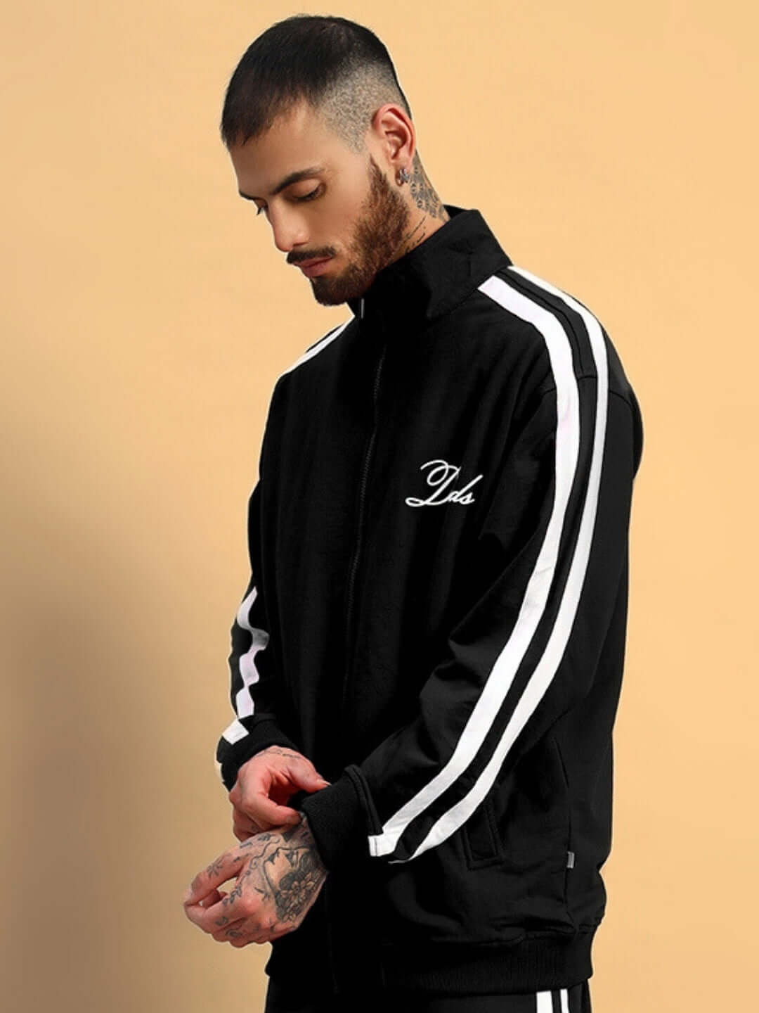 Man wearing black SCOTIA jacket with white stripes by DUDS, stylish and customizable, made-to-order piece.