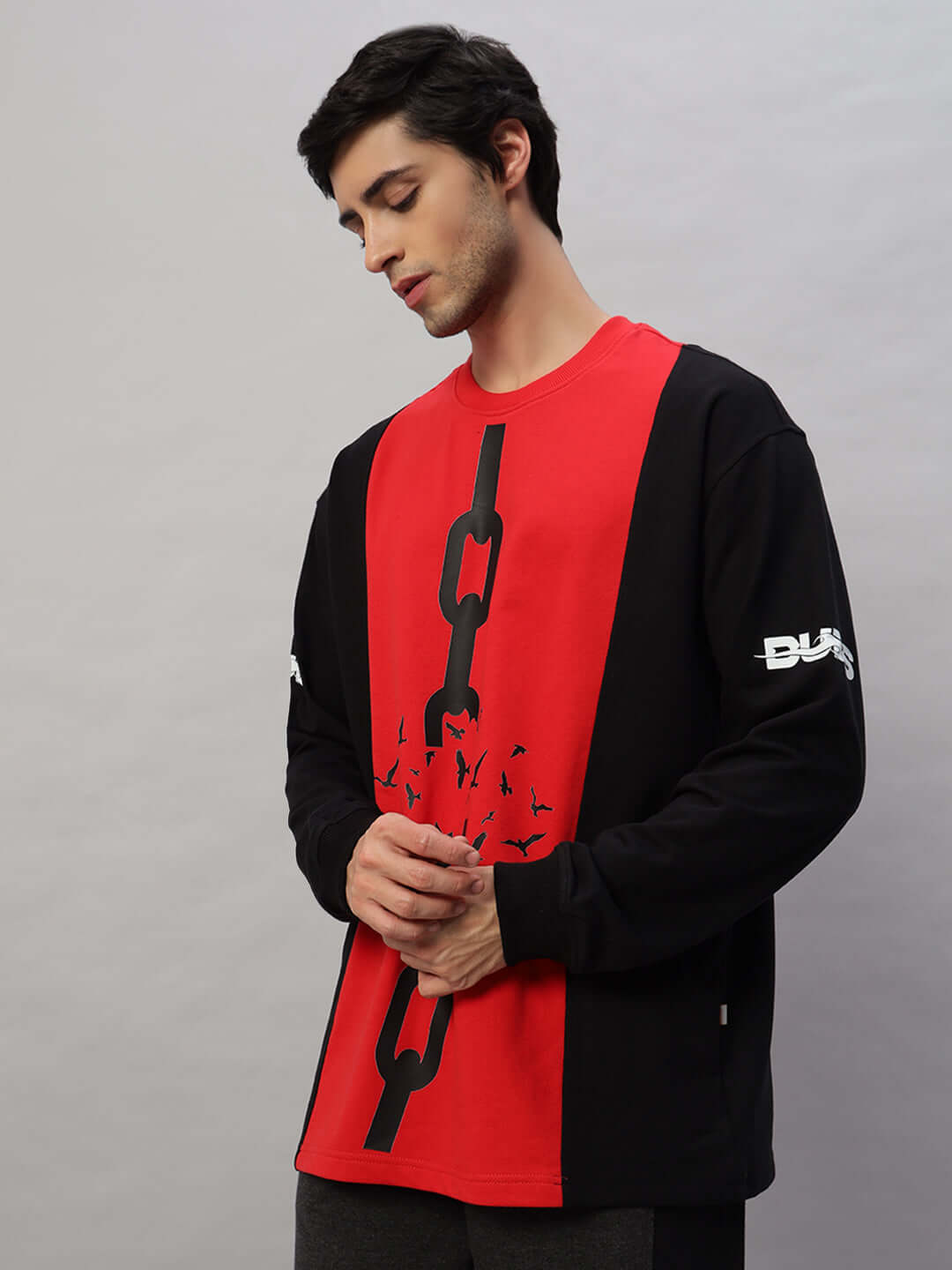Black-Red oversized sweatshirt made of premium cotton and elastane, featuring unique chain design; model wearing item.