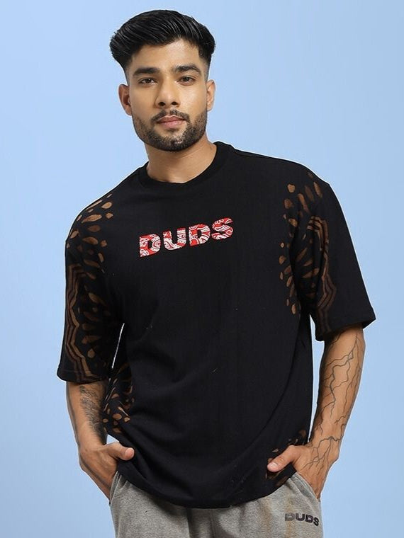 Model wearing SHADOW SWIRL TIE-DYE T-SHIRT BLACK with unique tie-dye pattern, perfect for casual style and comfort.