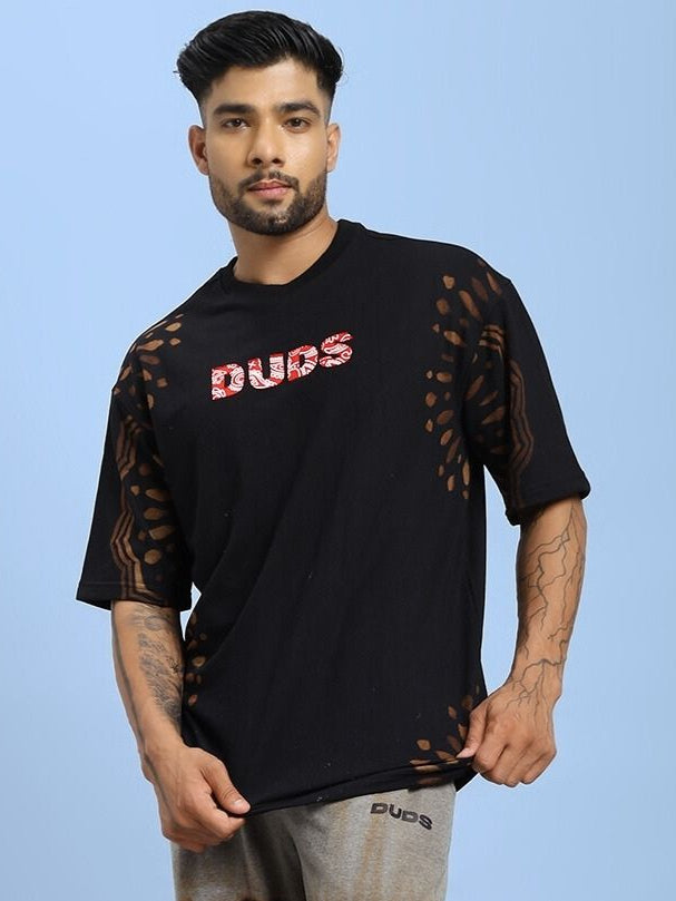 Man wearing a black SHADOW SWIRL TIE-DYE T-SHIRT BLACK with subtle patterns.