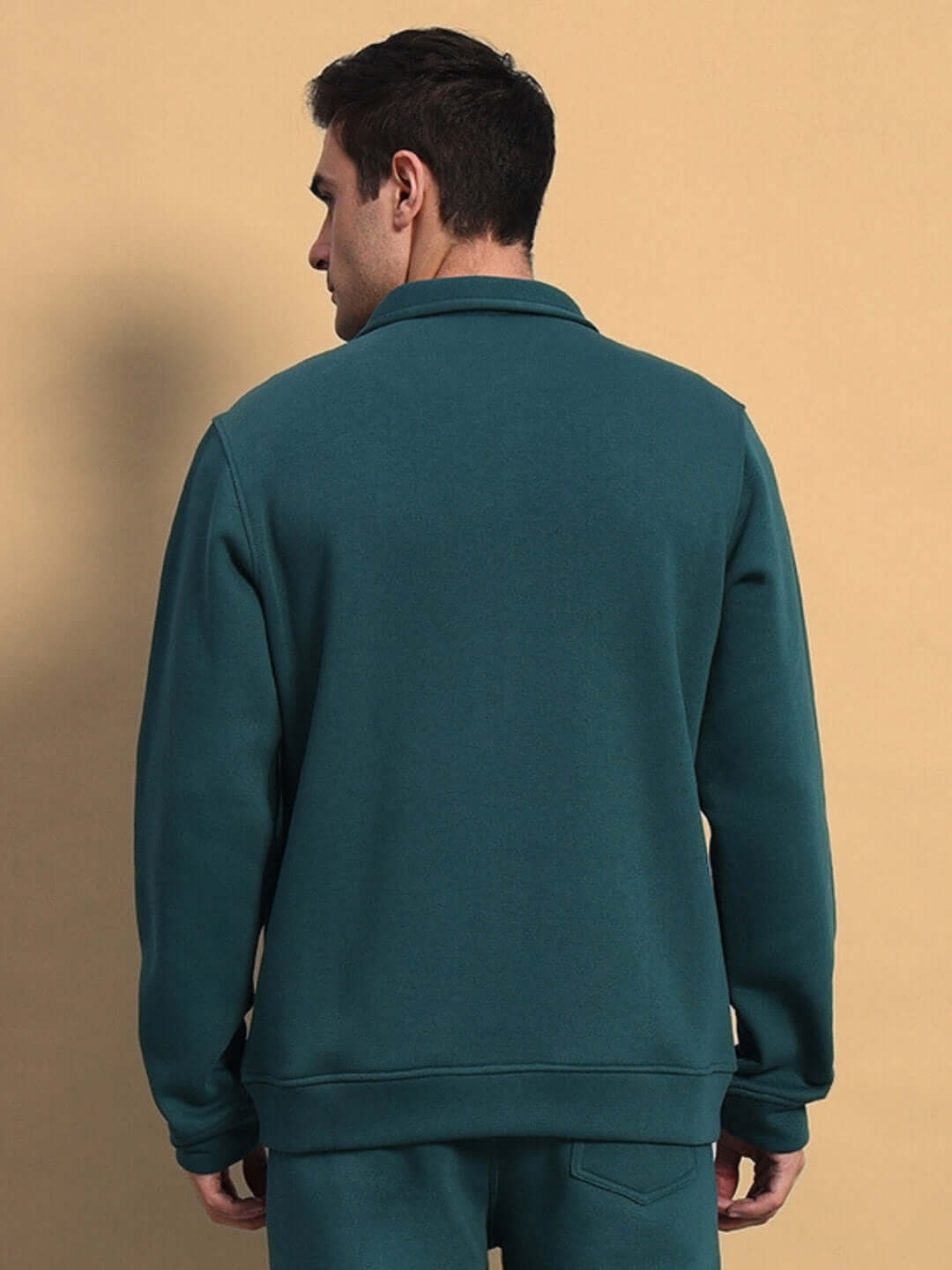 Back view of a teal green shaggy fleece jacket, highlighting its casual style and comfortable fit, available for customization at DUDS.