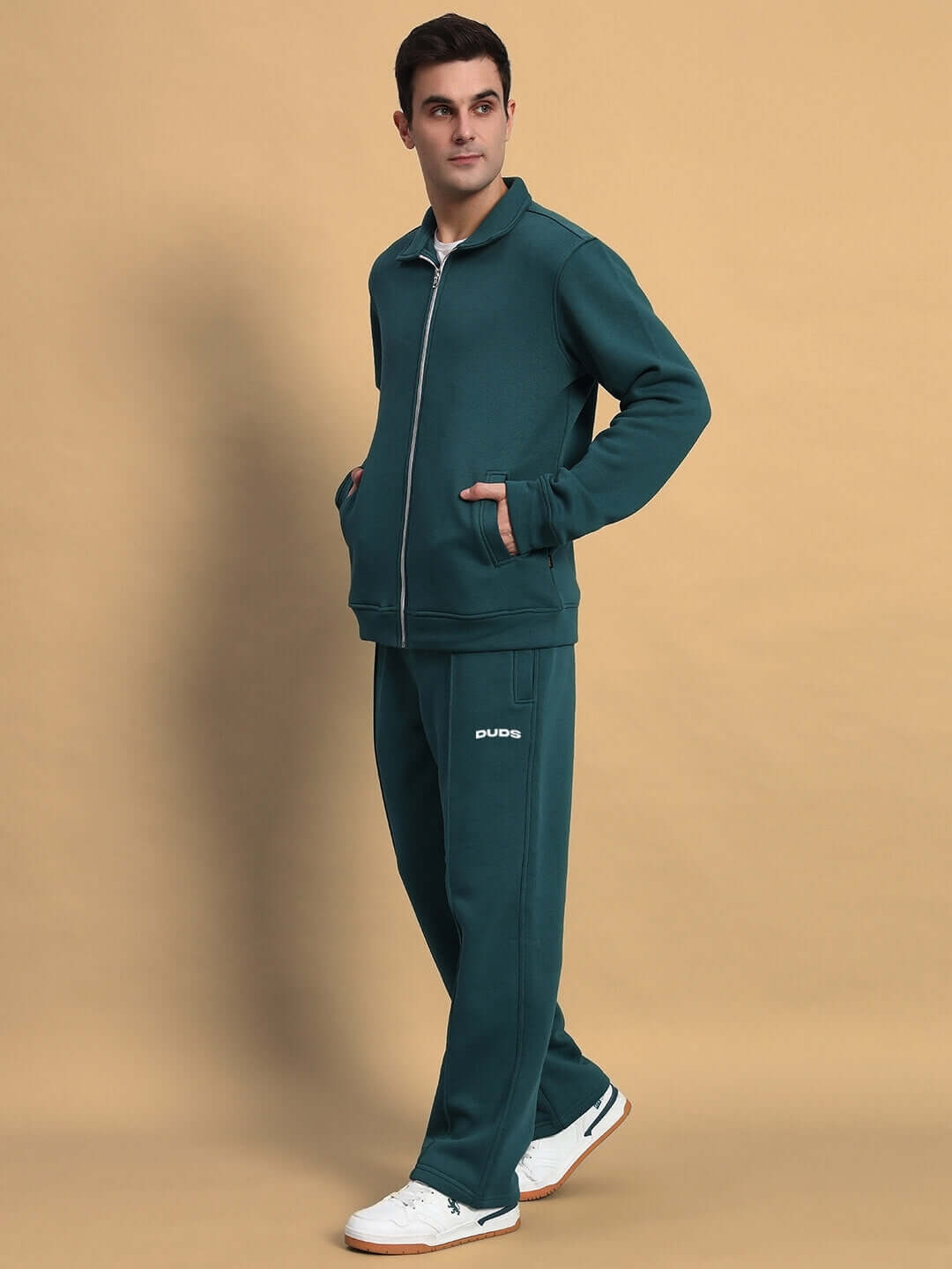 Model wearing SHAGGY ZIPPER FLEECE CO-ORD SET TEAL GREEN, standing with hands in pockets, showcasing comfortable fashion by DUDS.