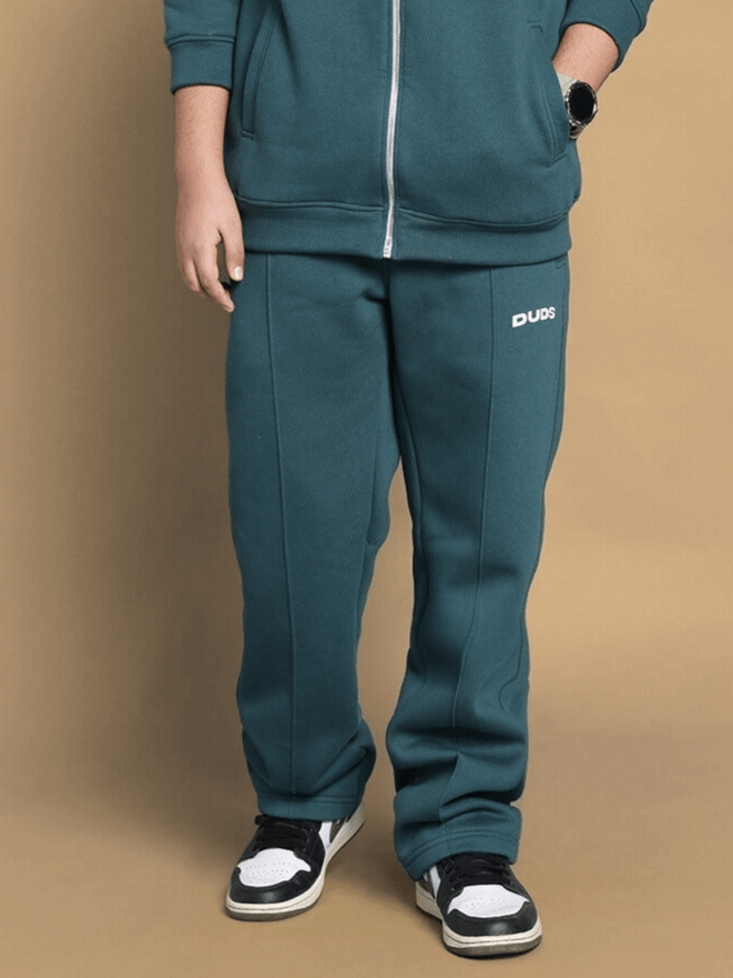 Child wearing teal green fleece joggers with Scooby-Doo design, showcasing comfort and style for boys and girls.