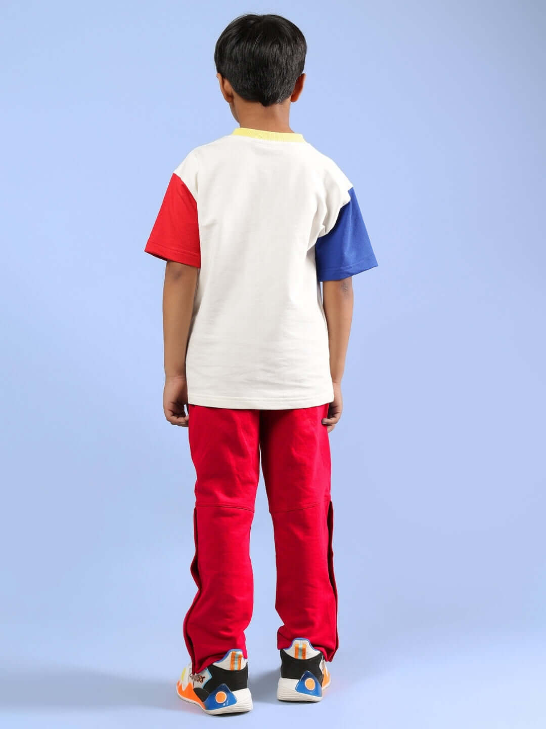 Child wearing SHARK FISH PRINTED CO-ORD FOR BOYS & GIRLS OFF WHITE-RED, showing back view with vibrant red pants and multicolor shirt.