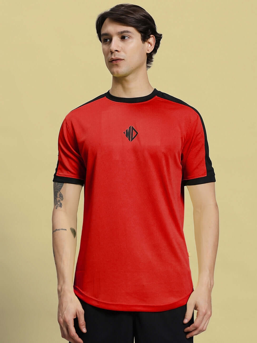 Person wearing SHERPA REGULAR FIT T-SHIRT RED made from sports polyester fabric.