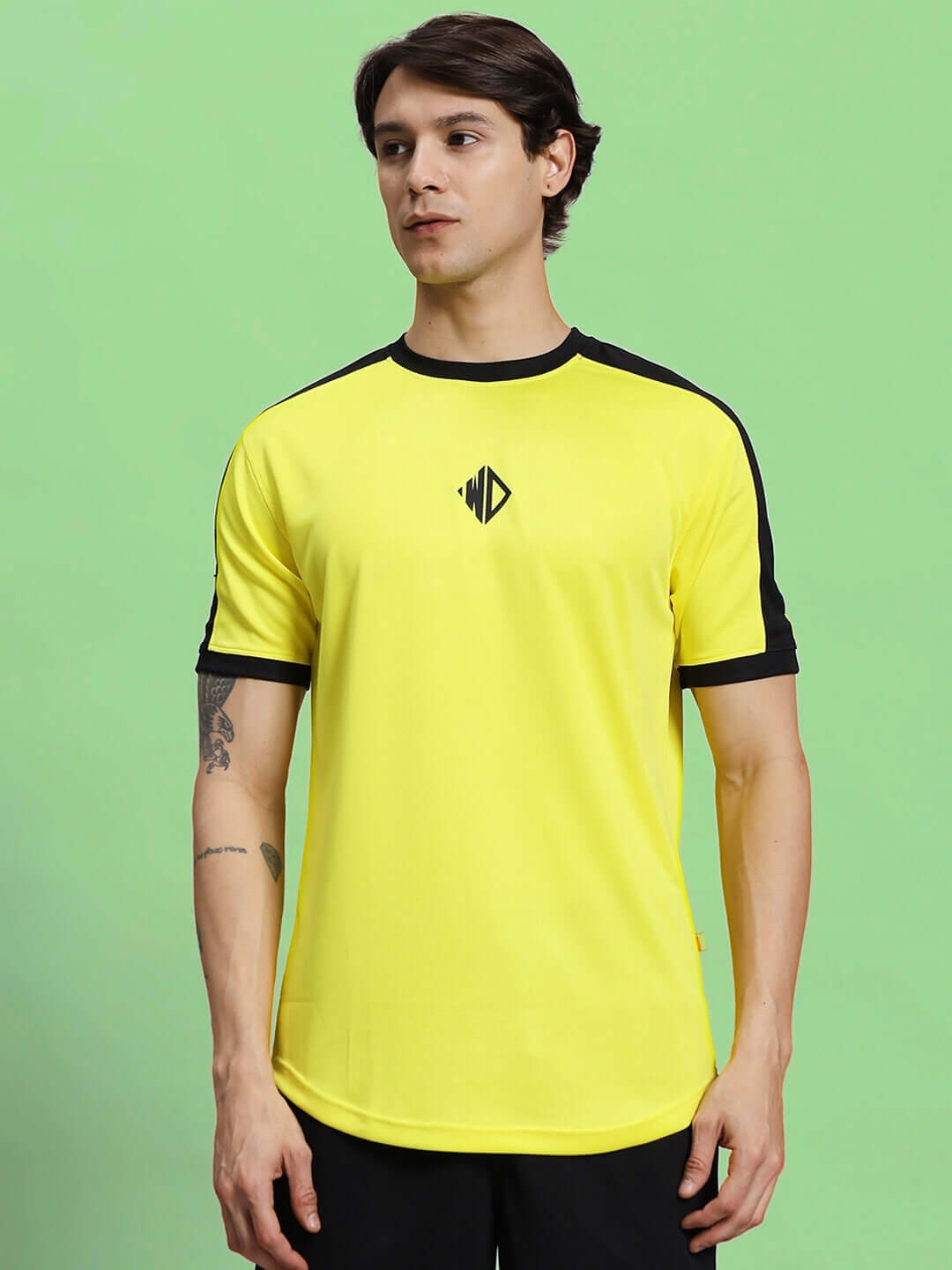 Male model wearing Sherpa regular fit T-shirt in yellow with black accents, made of sports polyester fabric, perfect for casual wear.