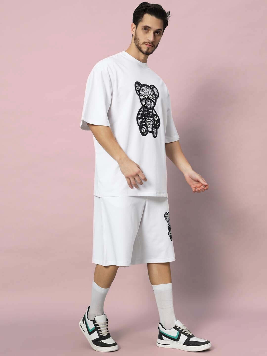 Model in SHIMMY CO-ORD SET (WHITE) featuring premium heavy cotton French terry fabric. Includes t-shirt and shorts with bear print.