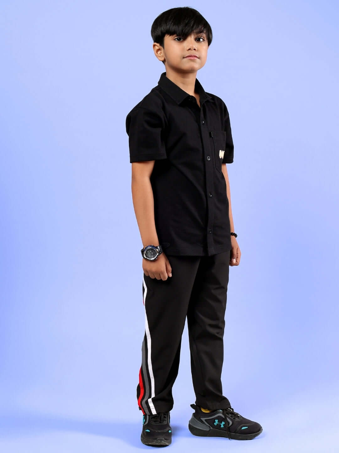Boy wearing SHINE CO-ORD FOR BOYS & GIRLS BLACK set, featuring black shirt and pants, perfect for stylish unisex fashion.