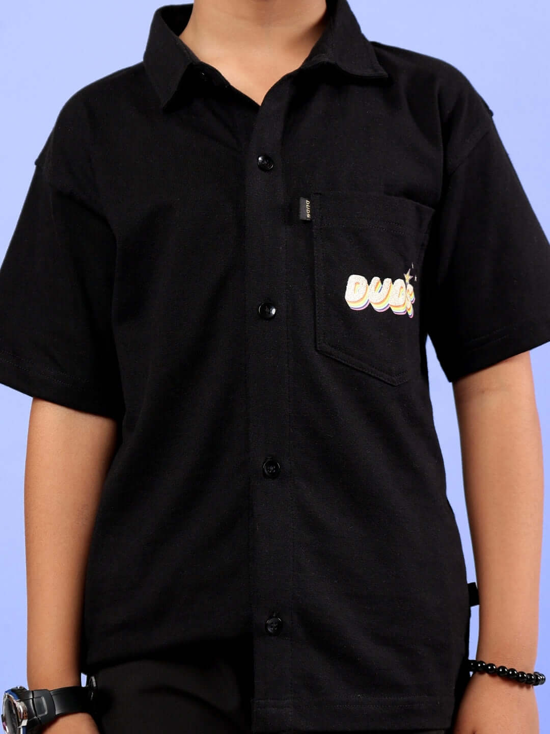 Black SHINE shirt for boys and girls, short sleeves, featuring DUDS logo, customizable fit available for prepaid orders.