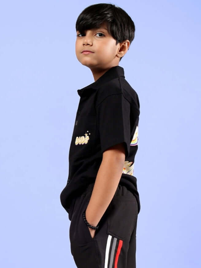 Child wearing black SHINE SHIRT by DUDS, a made-to-order article for boys & girls, featuring custom fit options and expert tailoring.