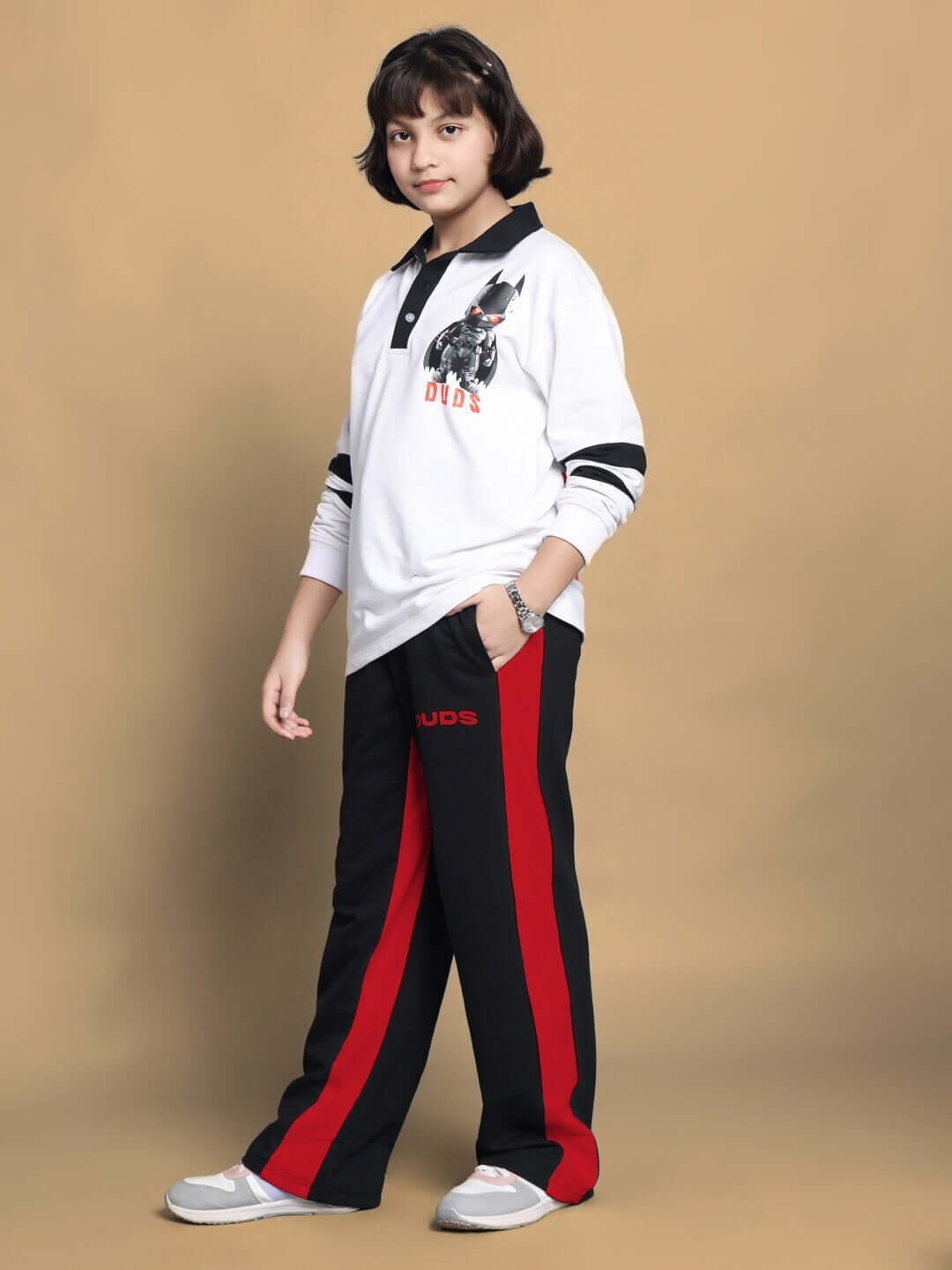 Child wearing side seam baggy jogger in black and red, fashion by DUDS, suitable for boys and girls, available in custom fit.