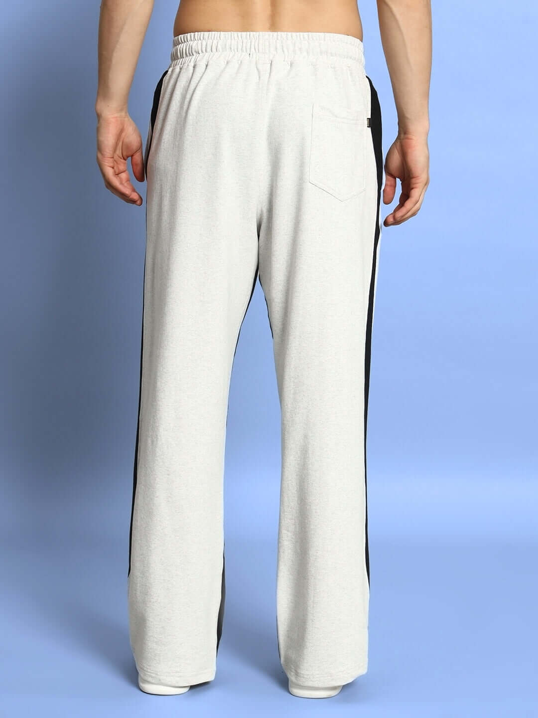 Back view of side seam baggy joggers in melange grey with black accents, highlighting custom fit options and made-to-order appeal by DUDS.