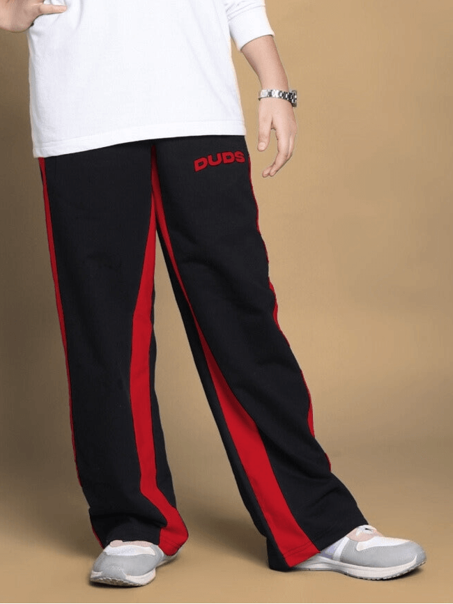 Child wearing black-red side seam baggy jogger from DUDS, showcasing the comfortable and stylish fit for boys and girls.