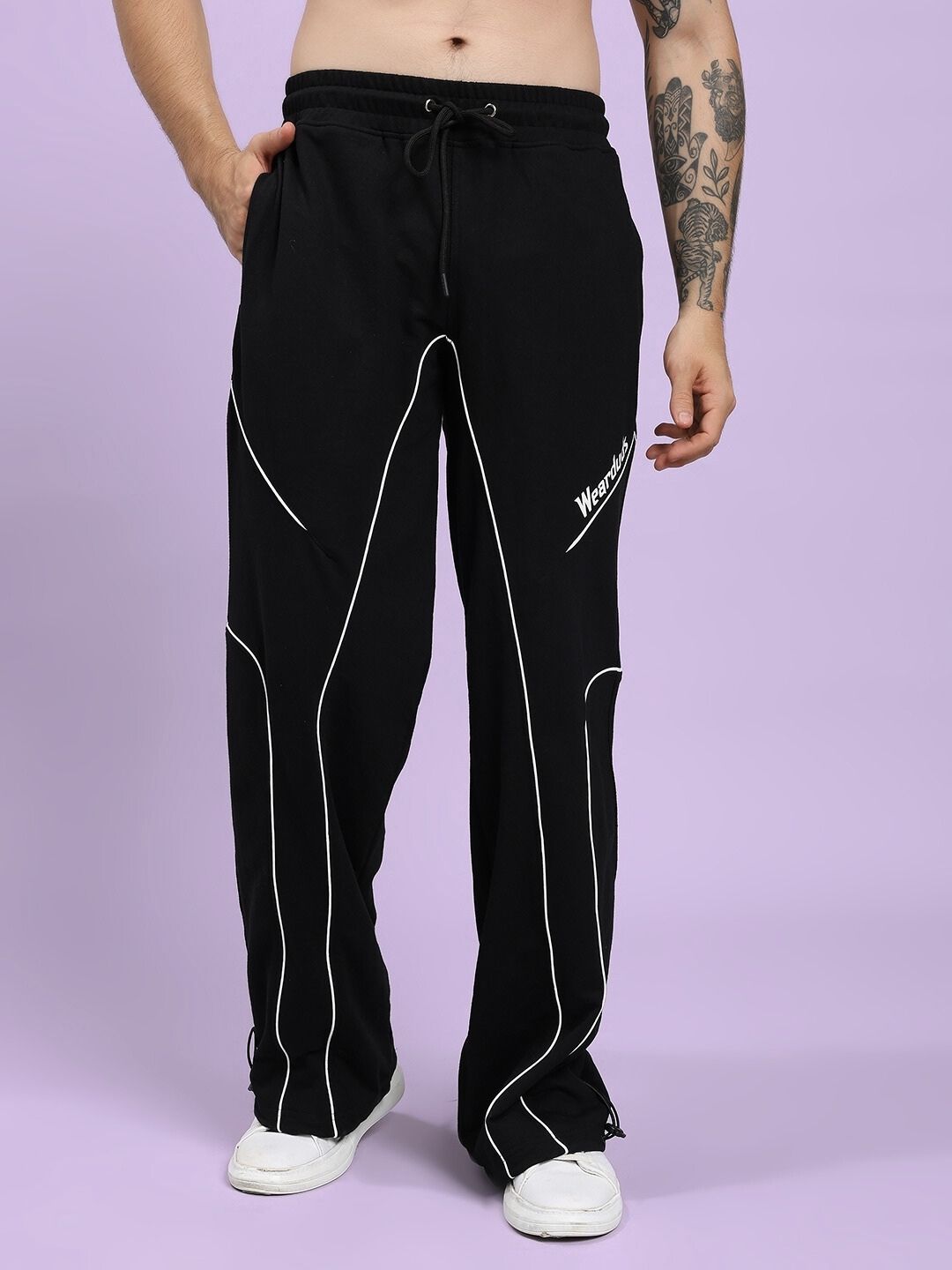 Stylish SIGNATURE PIPING JOGGERS BLACK with contrast piping detail, offering a chic look and relaxed fit for comfort in any setting.