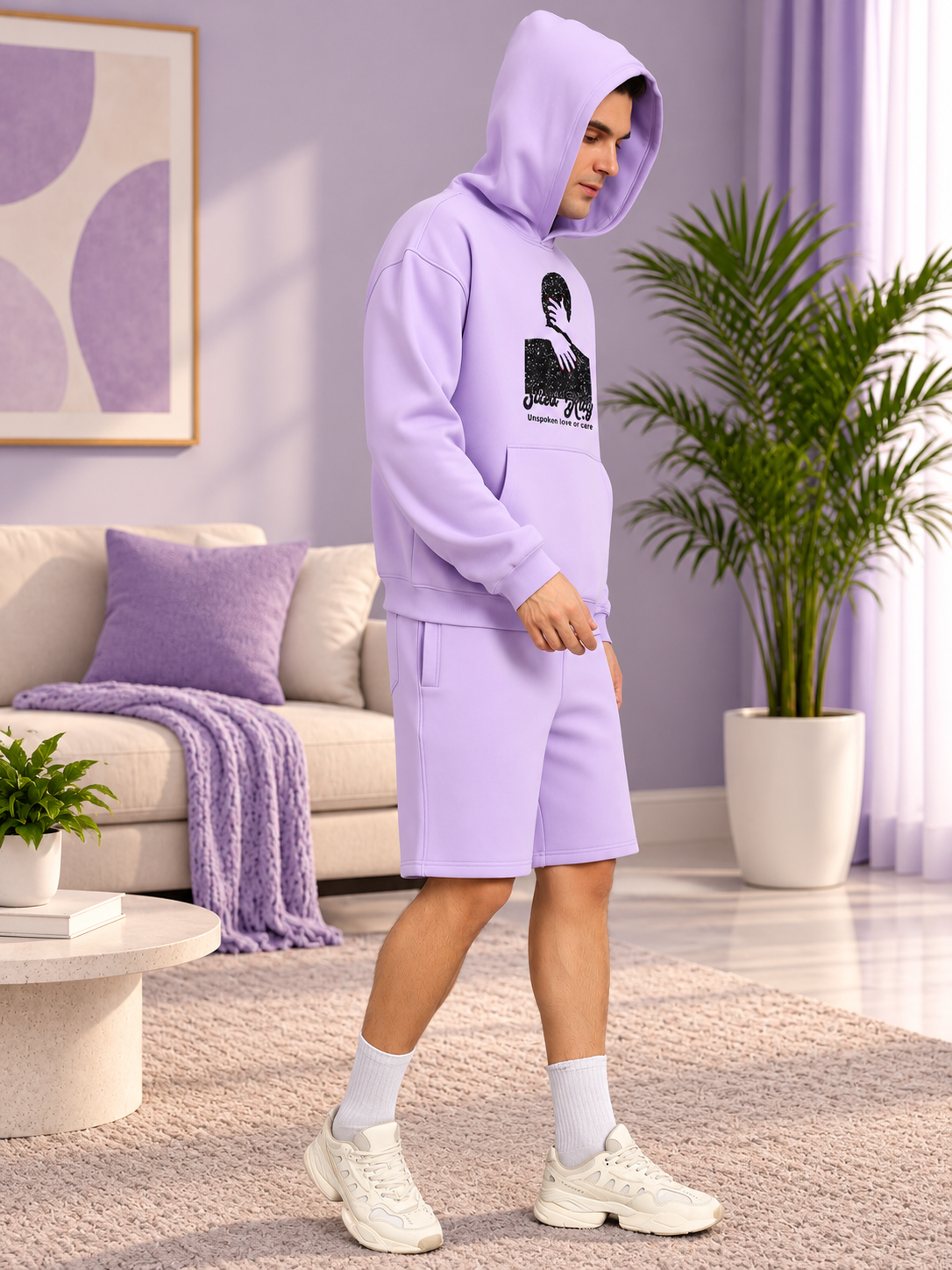 SILENT HUG PRINTED FLEECE CO-ORD LILAC worn by man in cozy home setting with plants and sofa