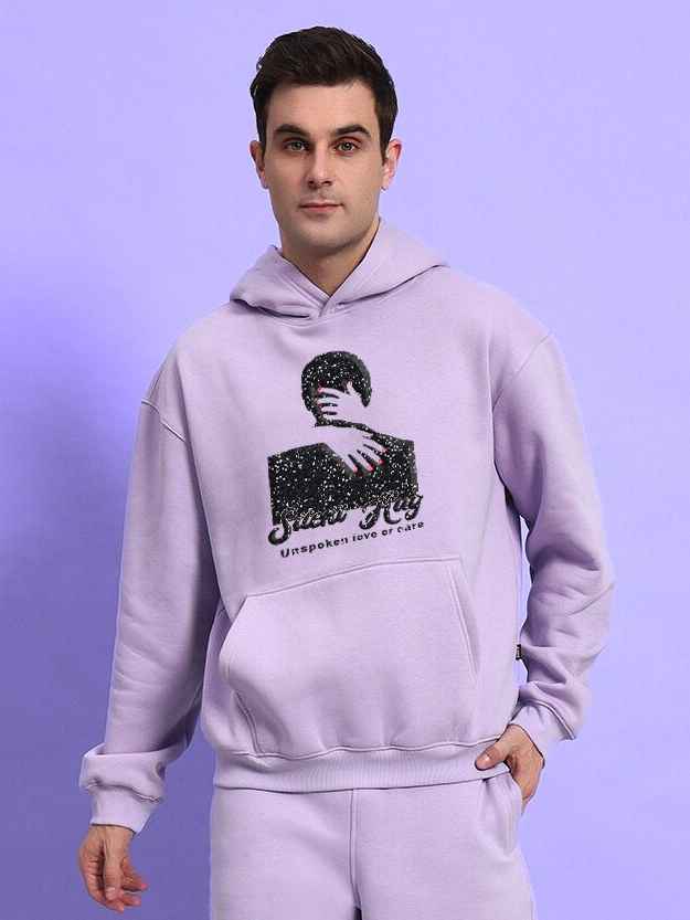 Man wearing SILENT HUG PRINTED FLEECE HOODIE LILAC with unique design, showcasing style and comfort in light purple