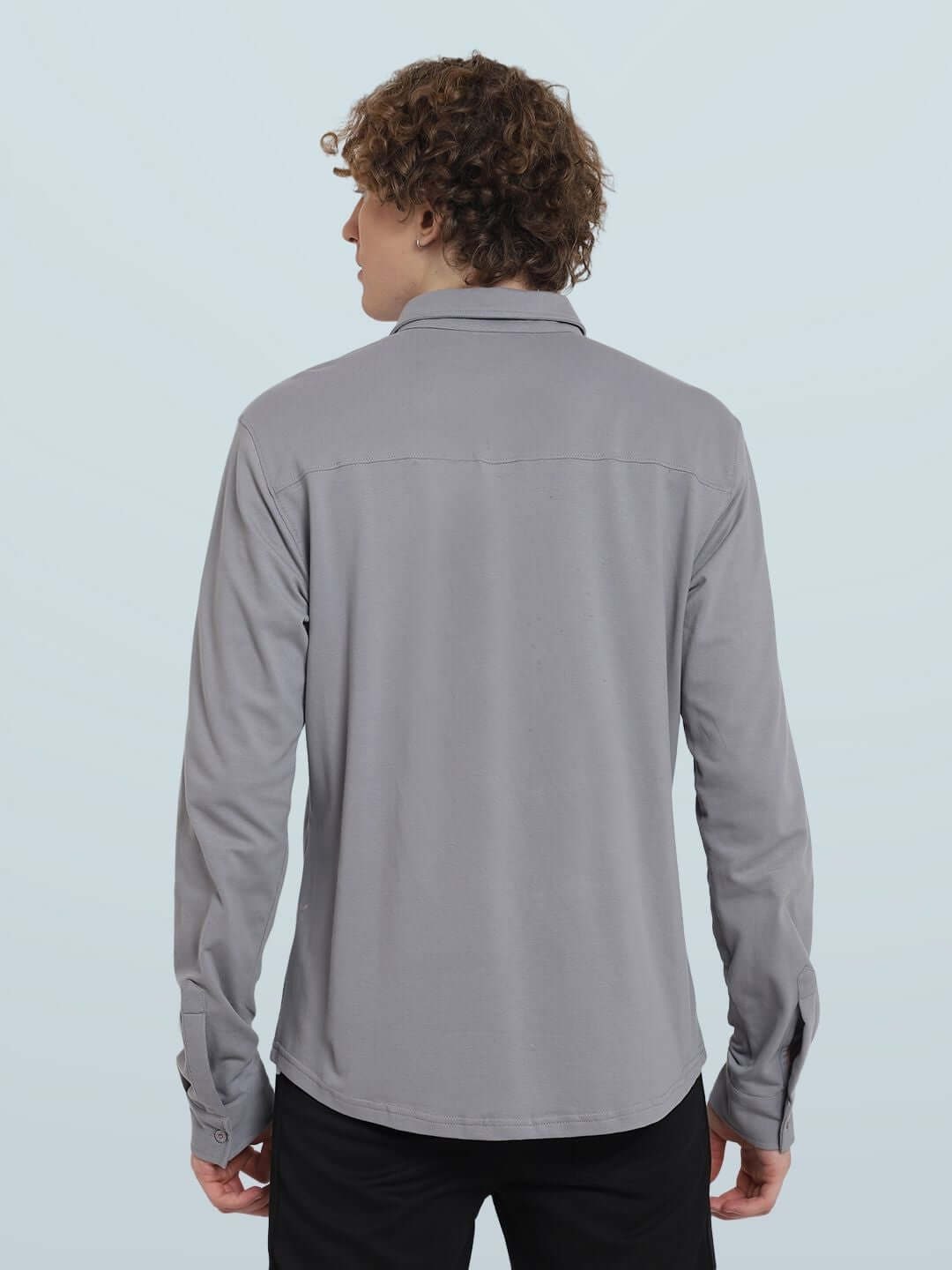 Model wearing Silver Grey Sporty Pique Shirt, full sleeve with curved hem. 100% cotton lycra, wrinkle-free, slim fit, rear view.