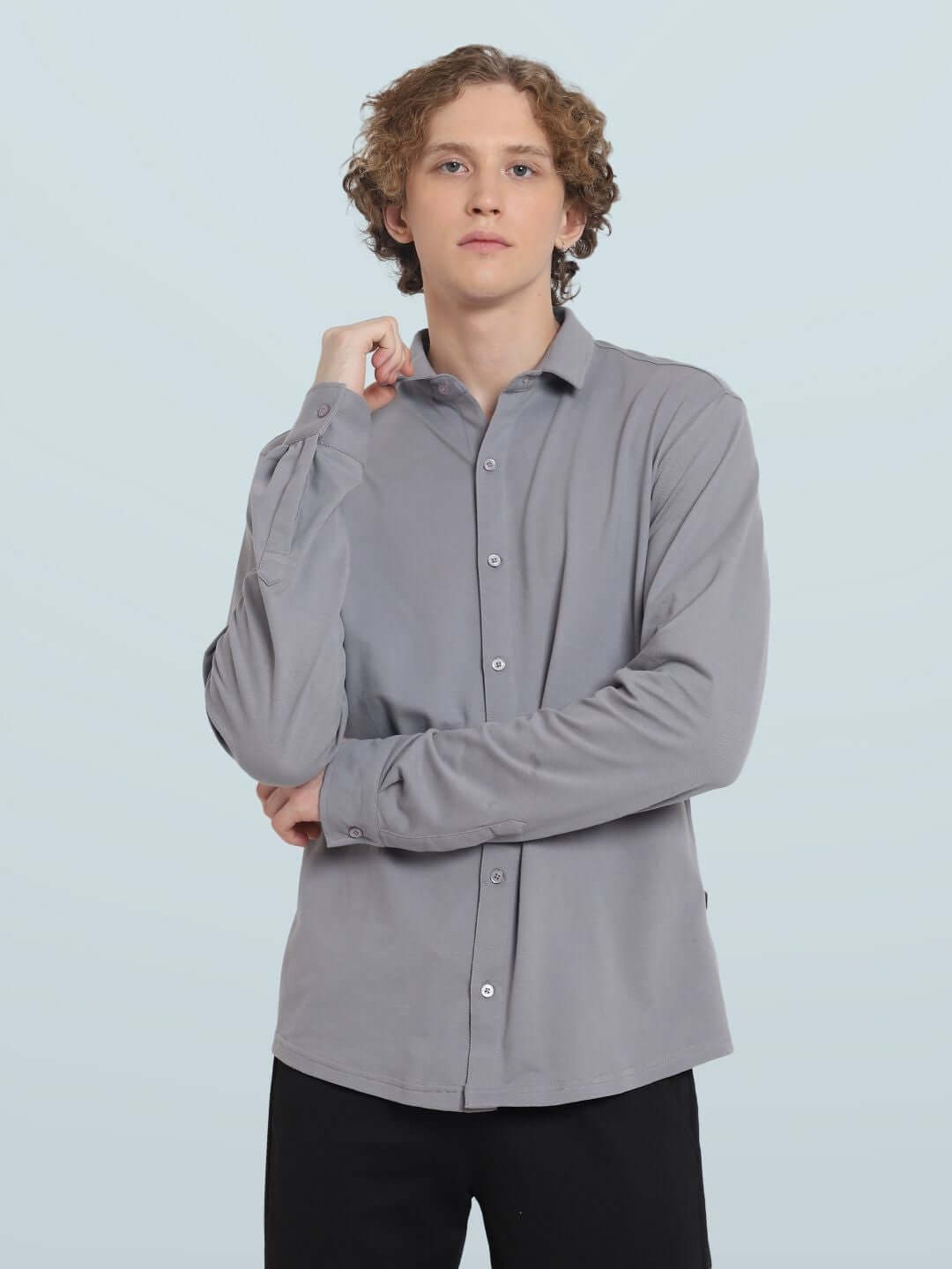 A man wearing a silver grey sporty pique shirt with full sleeves, showcasing a comfortable fit and wrinkle-free fabric.