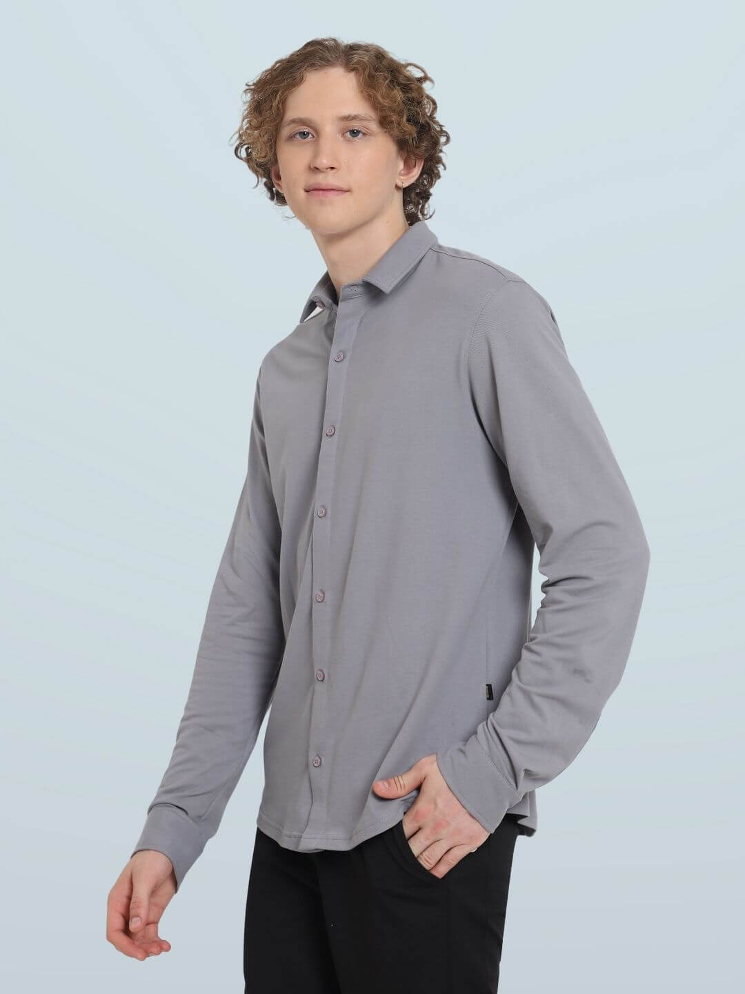 Model wearing a slim fit silver grey sporty pique shirt with full sleeves, highlighting its 100% cotton lycra stretch and wrinkle-free design.