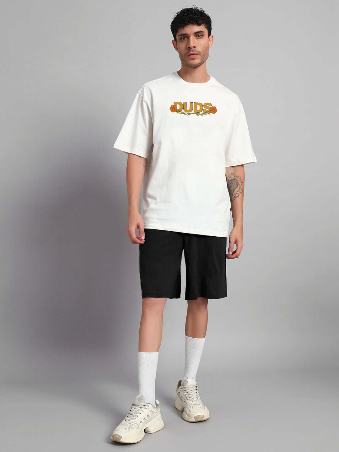 Man wearing Sitting Lion Co-ord Set in off-white and black, featuring premium cotton fabric and casual fit. Perfect for stylish comfort.
