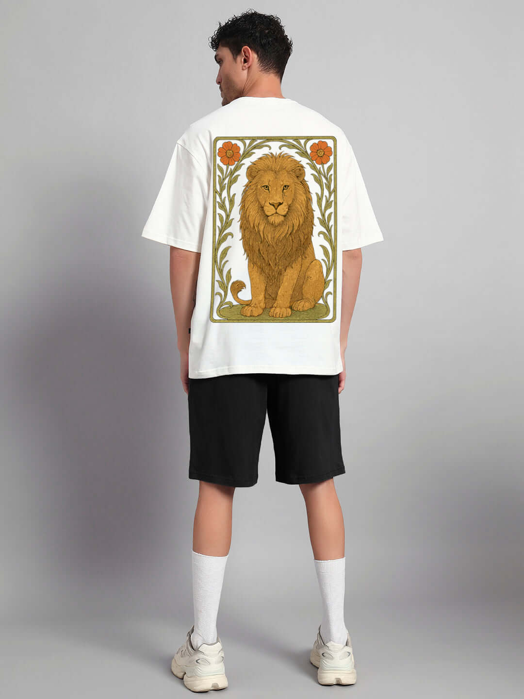 Man wearing Sitting Lion Co-ord Set featuring off-white t-shirt with lion print and black shorts, made from premium cotton fabric.