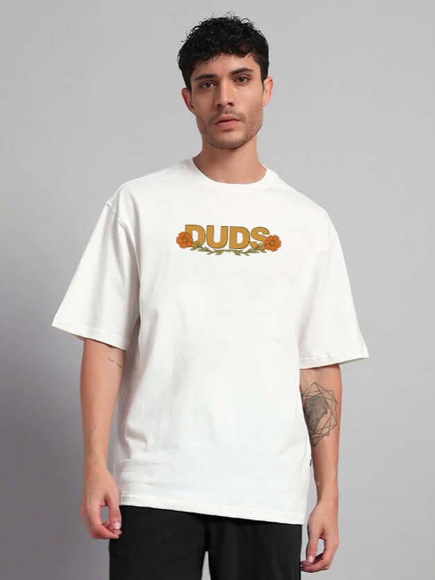 Man wearing Sitting Lion Oversized T-Shirt in Off White, premium cotton blend, featuring "DUDS" graphic. Casual fashion look.