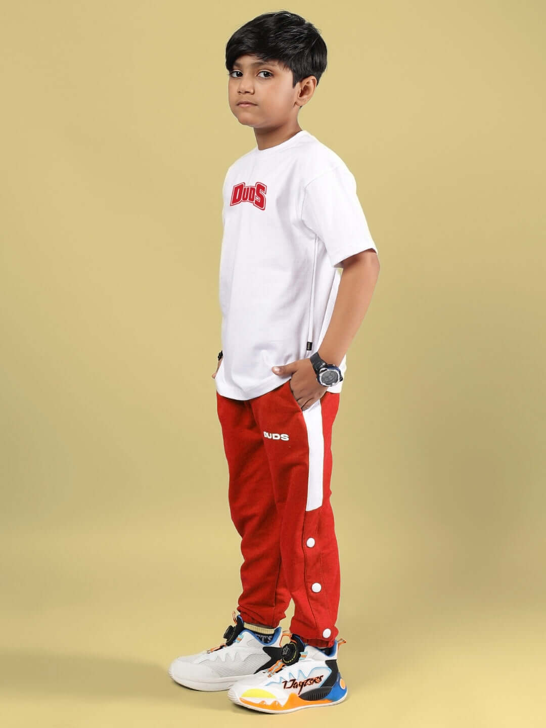 Boy wearing SKATER BANANA CO-ORD FOR BOYS & GIRLS WHITE-RED with white t-shirt and red pants from DUDS.