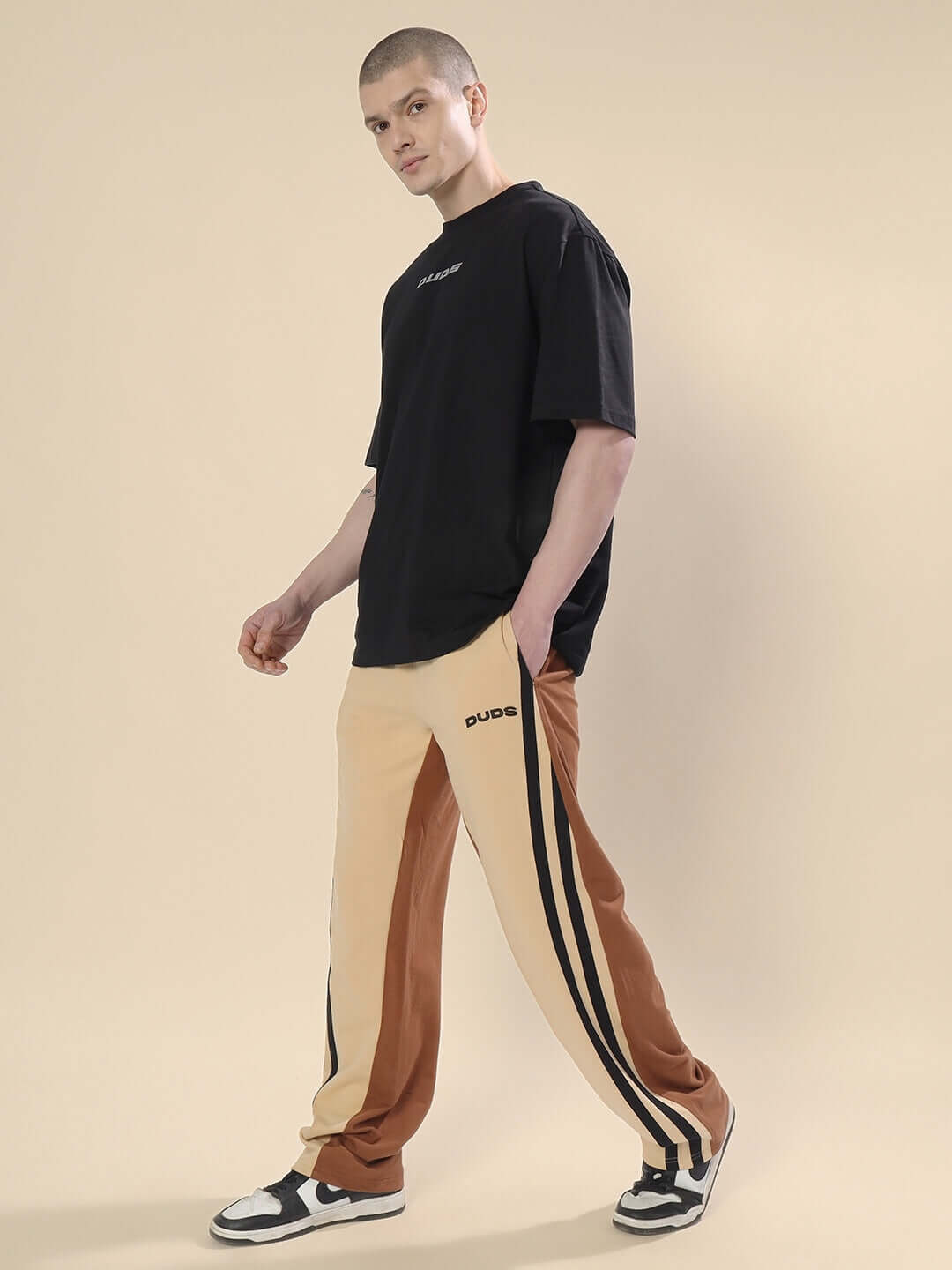 Man wearing Skater Korean Baggy Joggers in cream brown by DUDS, featuring a stylish and customizable fit, ideal for urban fashion.