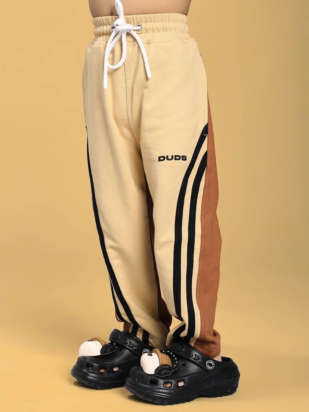 SKATER KOREAN JOGGER FOR BOYS AND GIRLS CREAM BROWN with side stripes and elastic waistband.