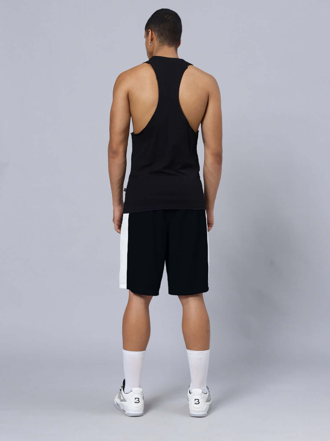 Back view of model wearing SKELETOR GYM CO-ORD SET SELEEVELESS BLACK with premium heavy gauge fabric and sports polyester bottom.