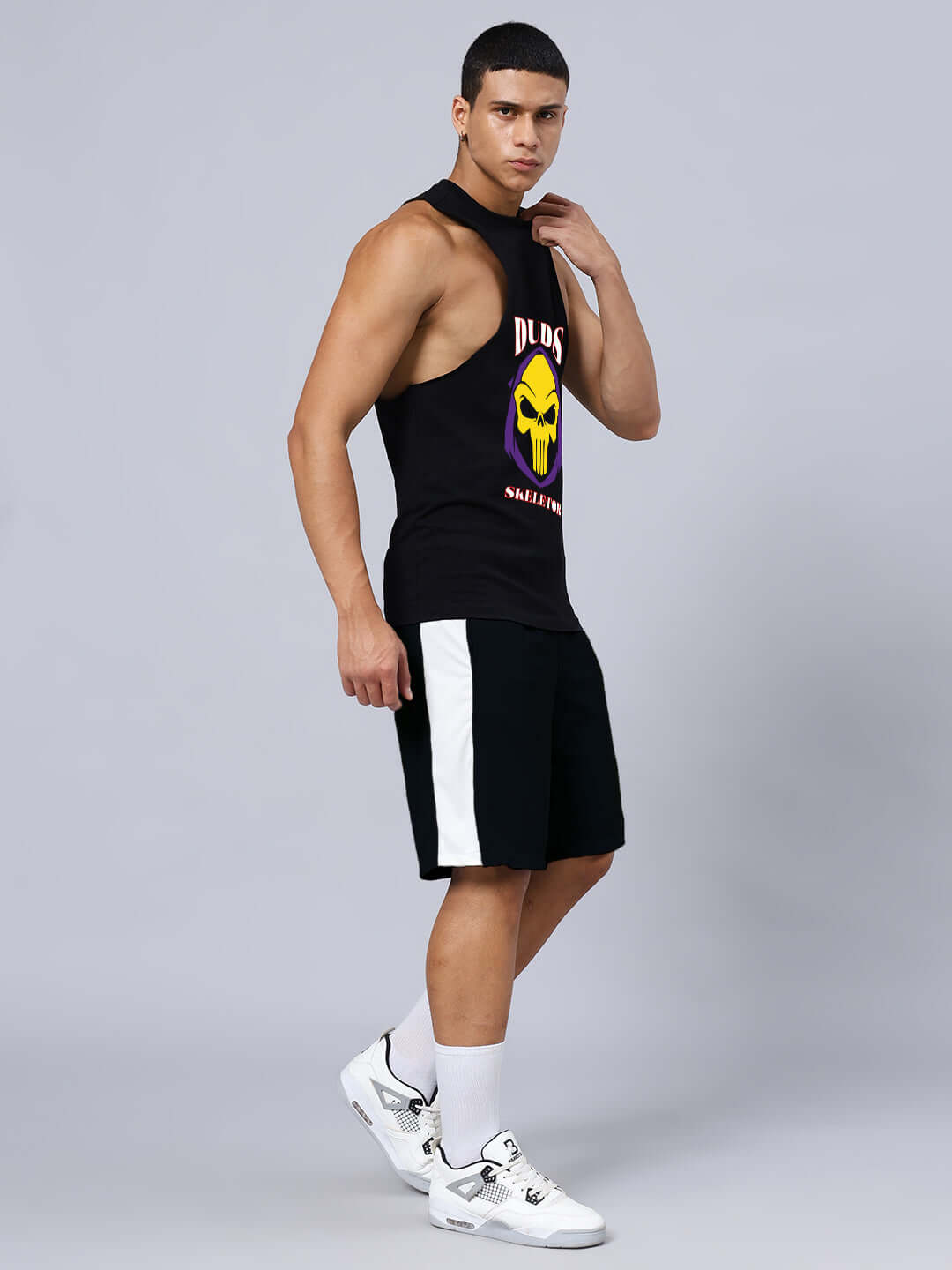 Man modeling SKELETOR GYM CO-ORD SET SELEEVELESS BLACK with premium cotton T-shirt and sports polyester shorts.