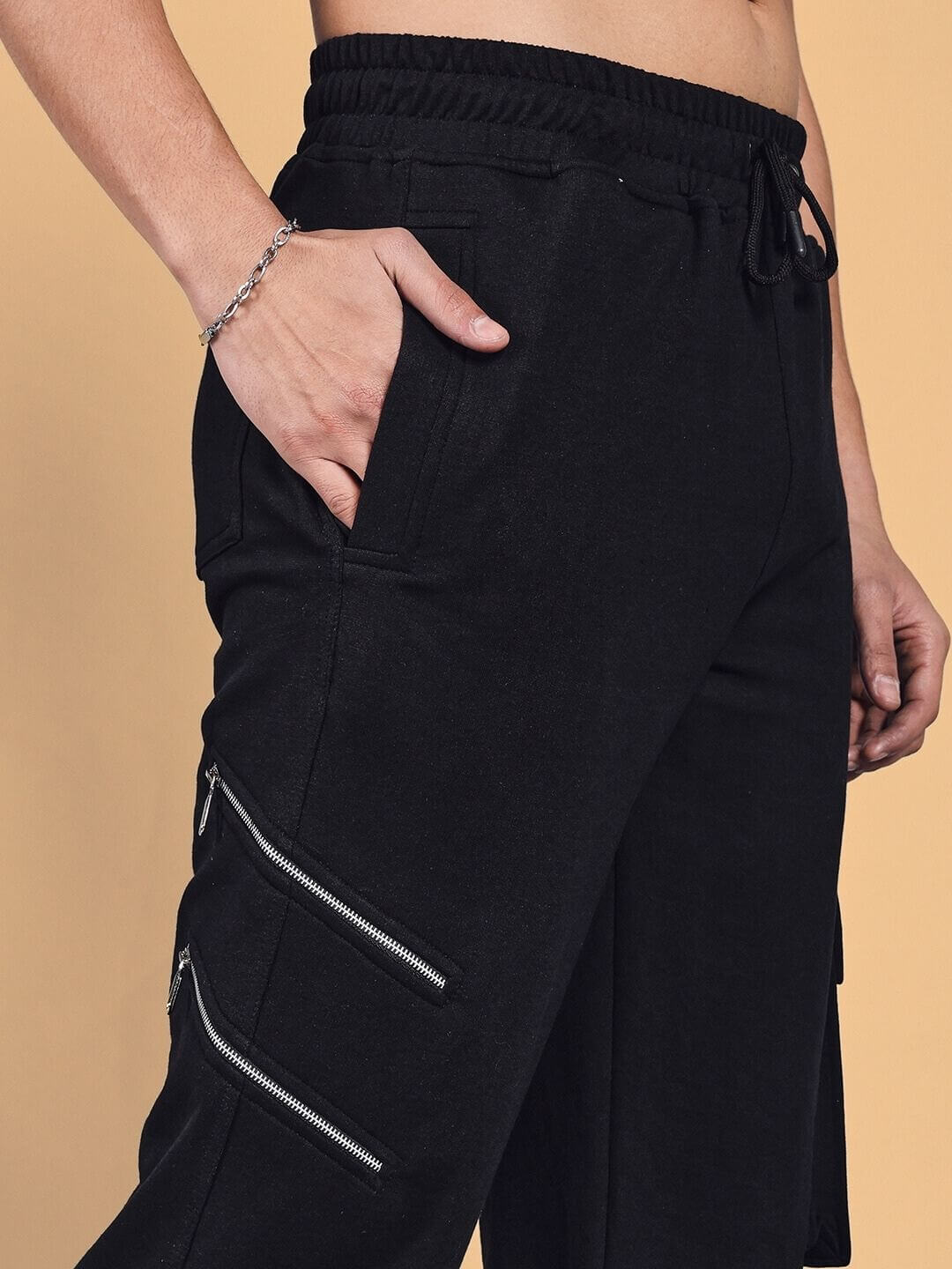 SKIDDER Cargo Pant in black, featuring stylish zippered pockets and adjustable waist, made to order with customizable fit options.