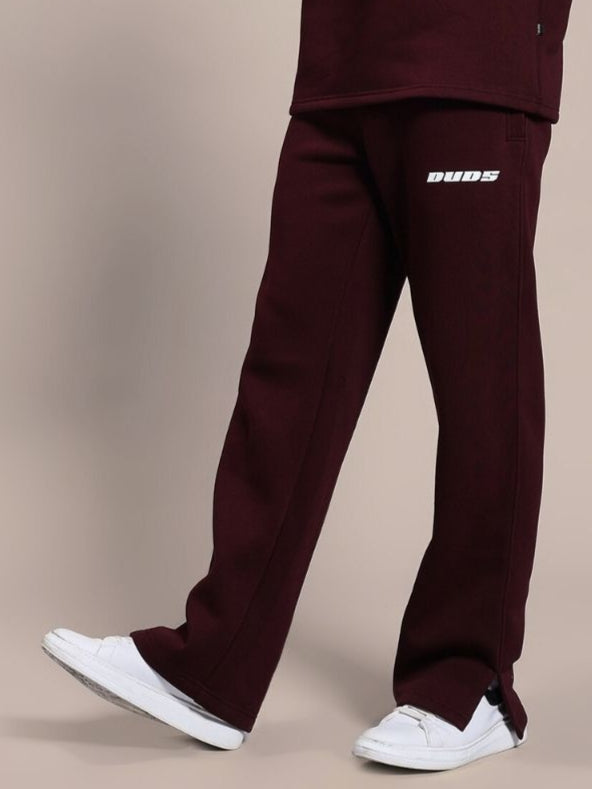 Person wearing SKODA COTTON FLEECE JOGGER MAROON with white sneakers.