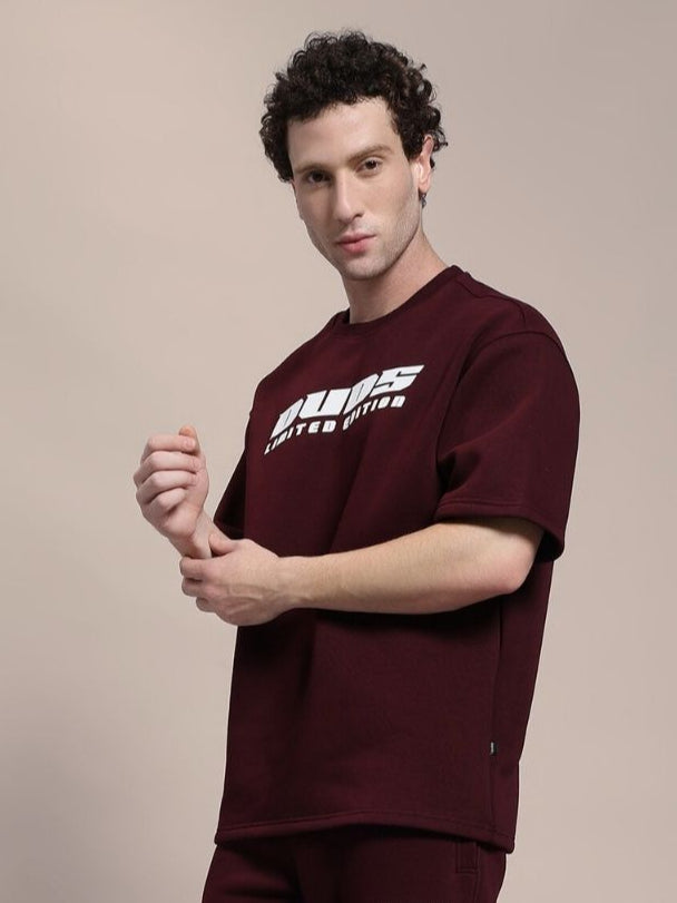 Man wearing SKODA FLEECE OVERSIZED T-SHIRT MAROON for a stylish and comfortable look.