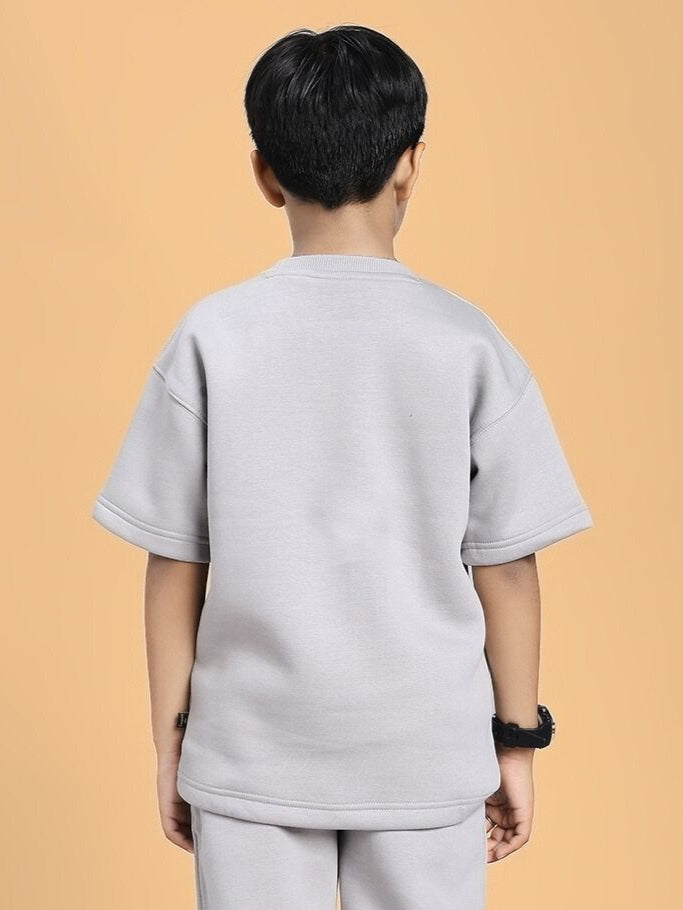 Back view of child wearing SKODA FLEECE T-SHIRT FOR BOYS AND GIRLS GREY with cozy fleece lining for warmth.