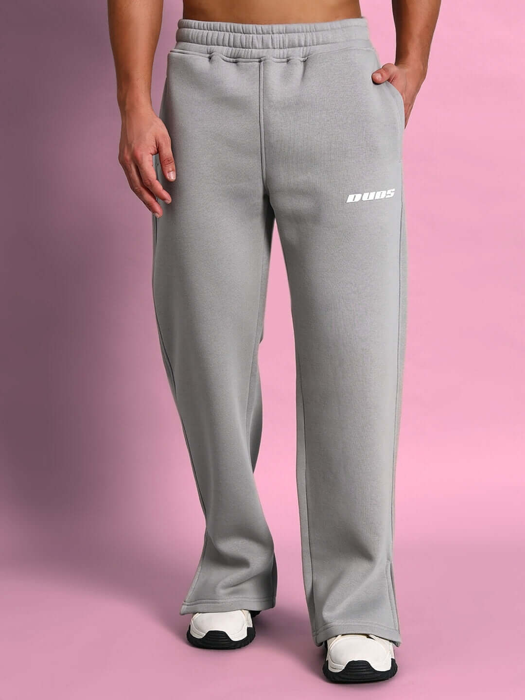 Person wearing SKODA COTTON FLEECE CO-ORD GREY joggers on pink backdrop