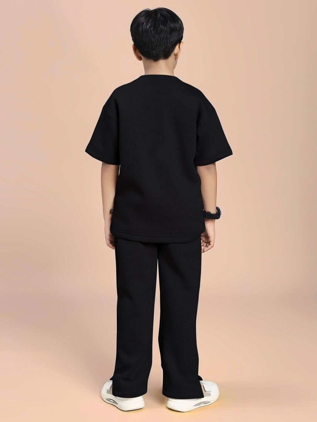 Child wearing SKODA FLEECE CO-ORD FOR BOYS AND GIRLS BLACK, showcasing comfortable and stylish black fleece outfit from the back view.