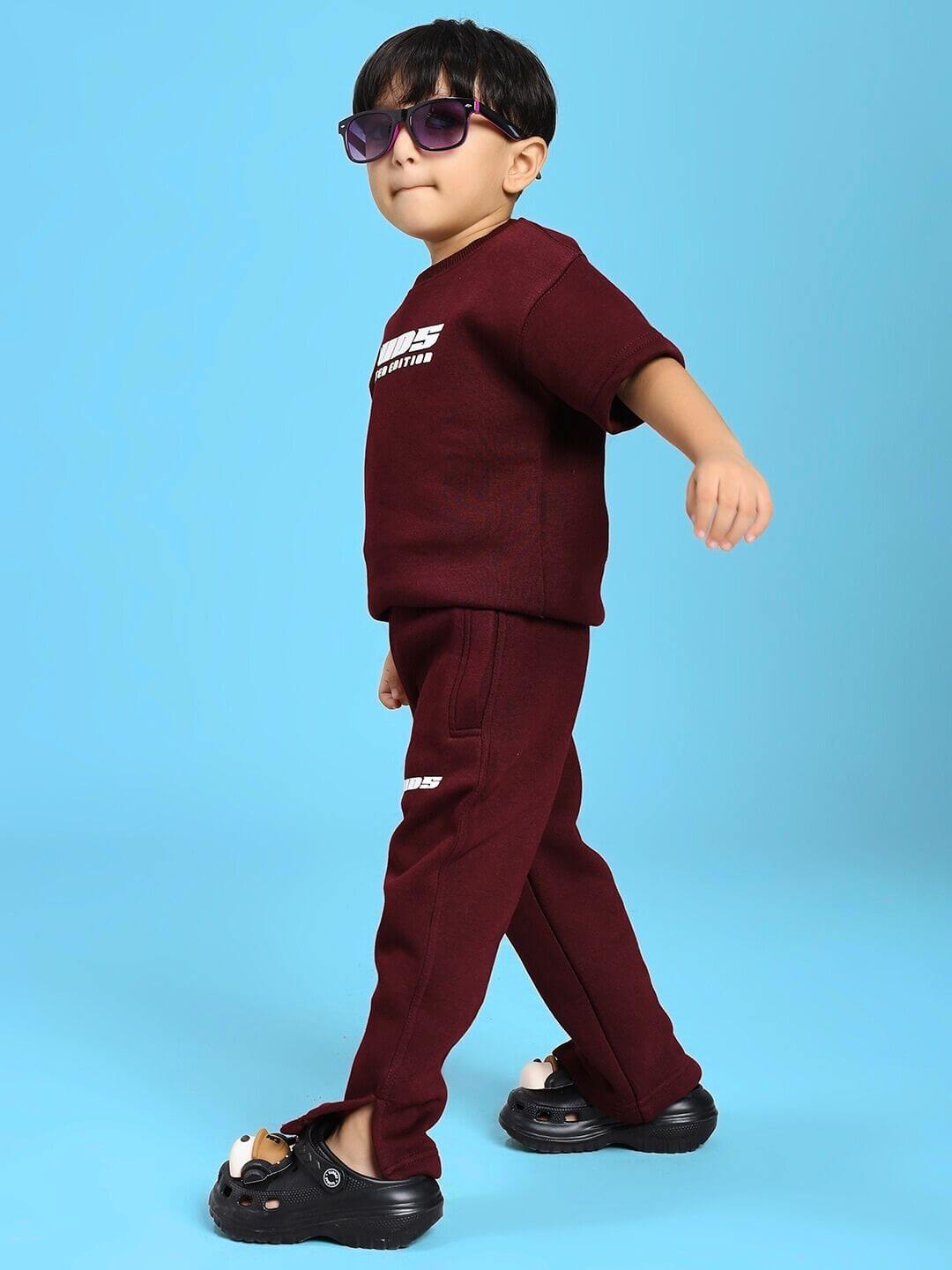 Child wearing SKODA FLEECE CO-ORD FOR BOYS AND GIRLS MAROON set, featuring a maroon hoodie and joggers, perfect for fall adventures.