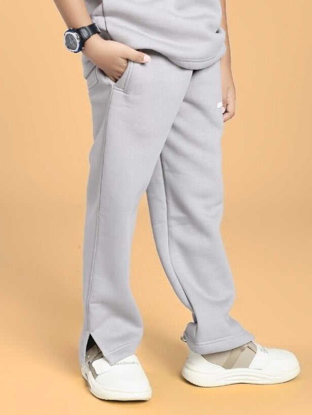 Child wearing SKODA FLEECE JOGGER FOR BOYS AND GIRLS GREY, showing relaxed fit and style.
