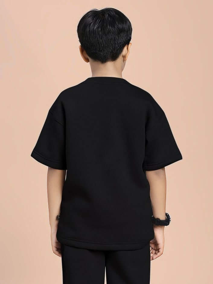 Back view of a child wearing a SKODA FLEECE T-SHIRT FOR BOYS AND GIRLS BLACK, showing the sleek, modern design and ultra-soft material.