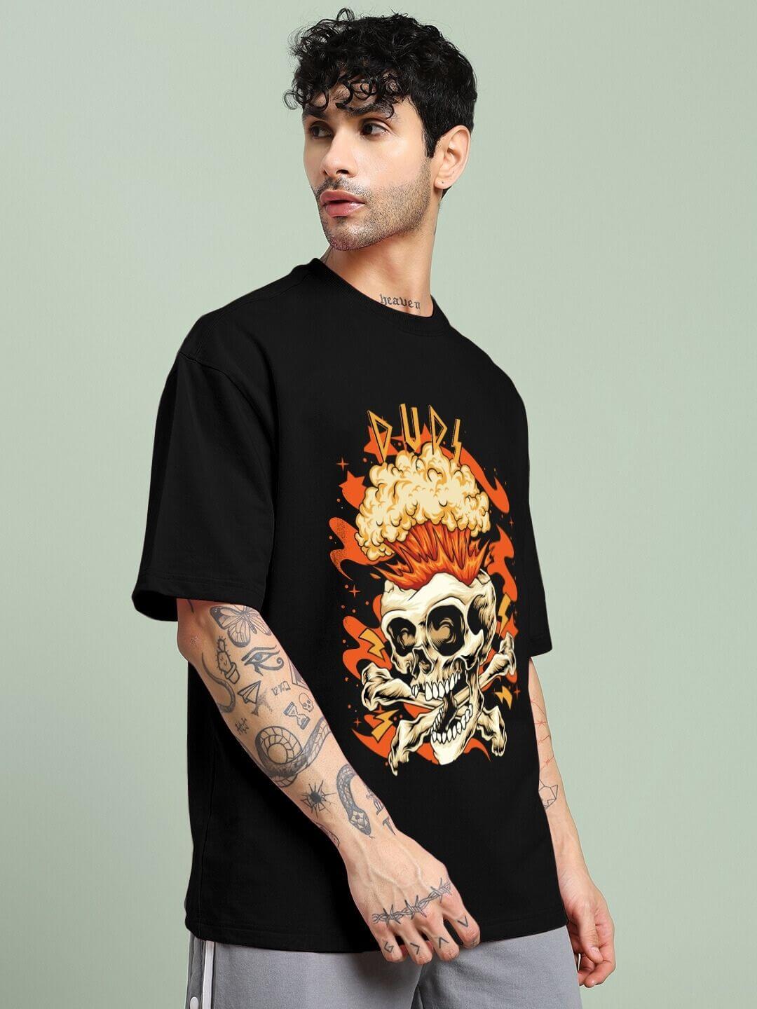 Man wearing a SKULL BLAST FIRE PRINT OVERSIZED T-SHIRT BLACK with bold skull and fire graphics, showcasing street fashion style.