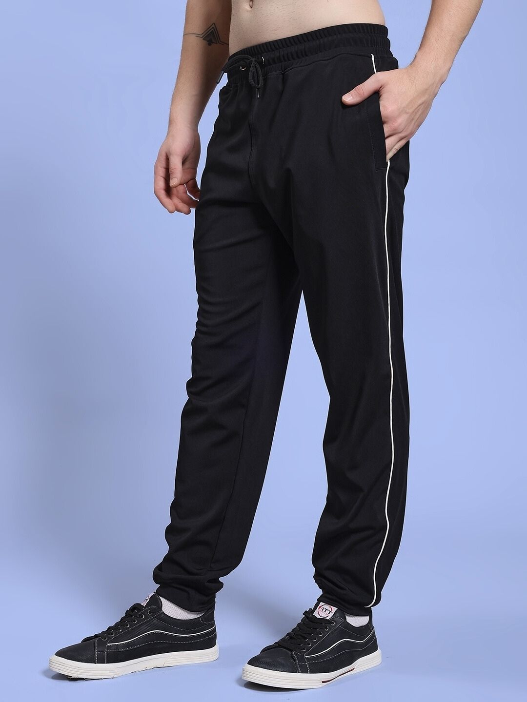 Man wearing SKY BOLT RELAXED FIT JOGGER BLACK with relaxed silhouette in a streetwear style, showcasing comfort and modern design.