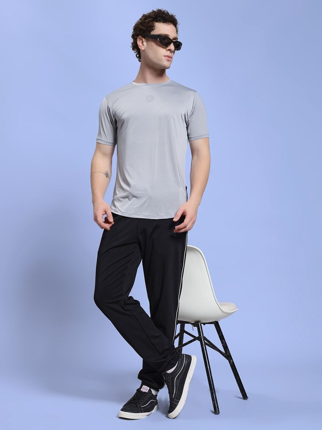 Fashion model wears SKY BOLT RELAXED FIT JOGGER BLACK with a grey shirt, showcasing casual streetwear style.