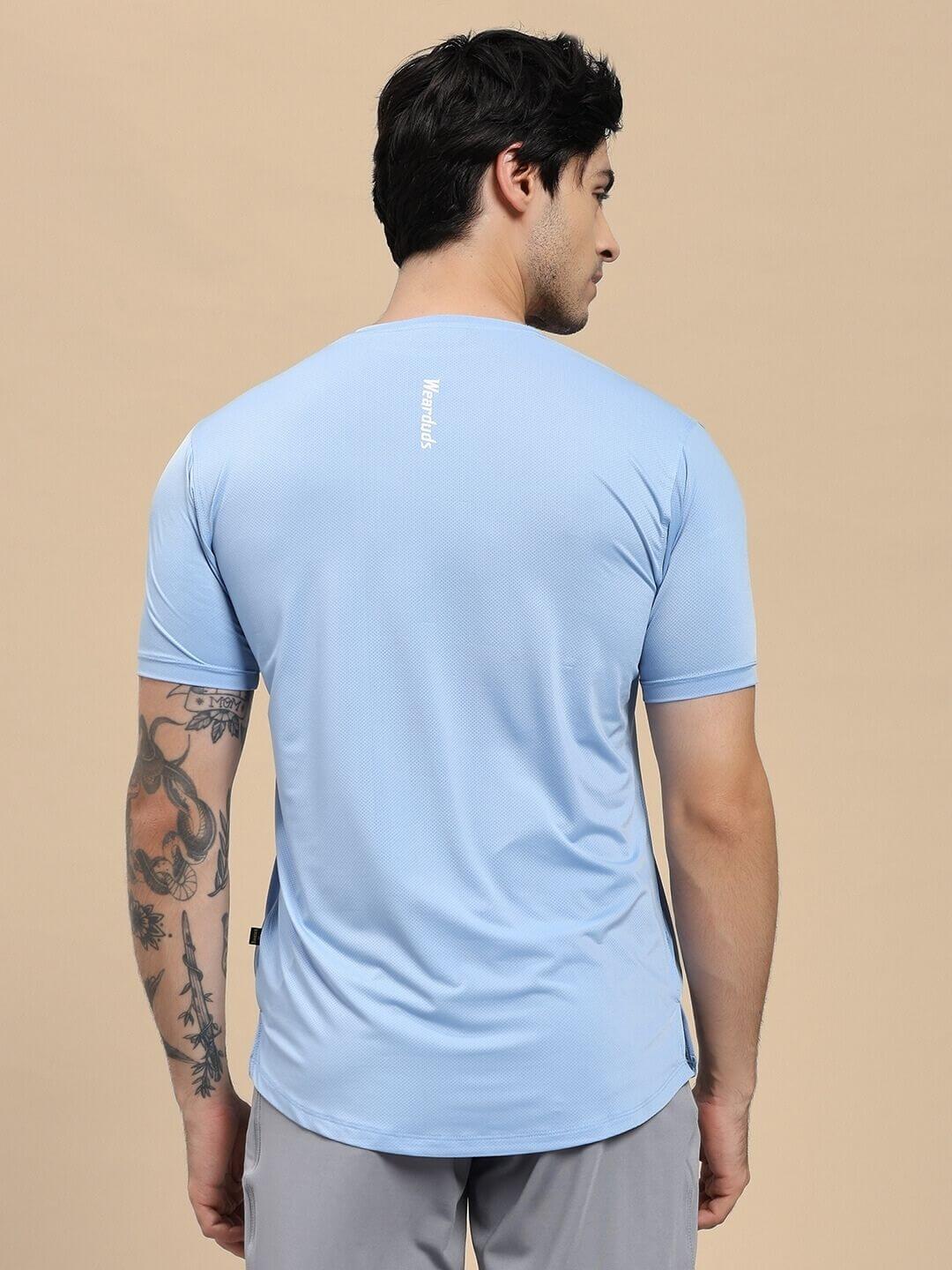 Back view of model wearing SKYLINE REGULAR FIT T-SHIRT LIGHT BLUE in casual setting, showcasing comfortable and stylish design.