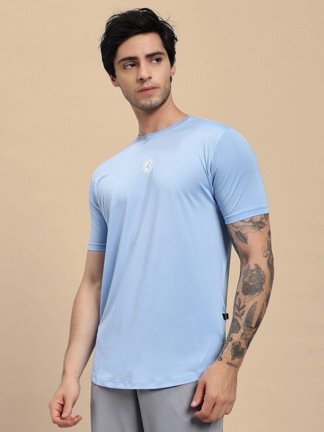 Man wearing SKYLINE REGULAR FIT T-SHIRT LIGHT BLUE, showcasing the casual and stylish design for a cool and comfortable fit.