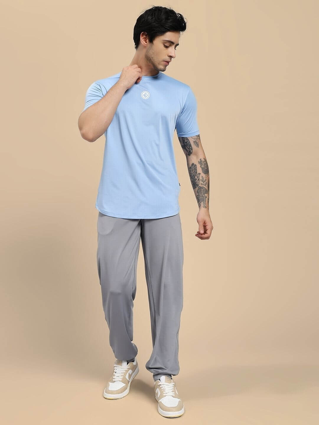 Man wearing SKYLINE REGULAR FIT T-SHIRT LIGHT BLUE, showcasing breathable fabric and classic style in a casual outfit.
