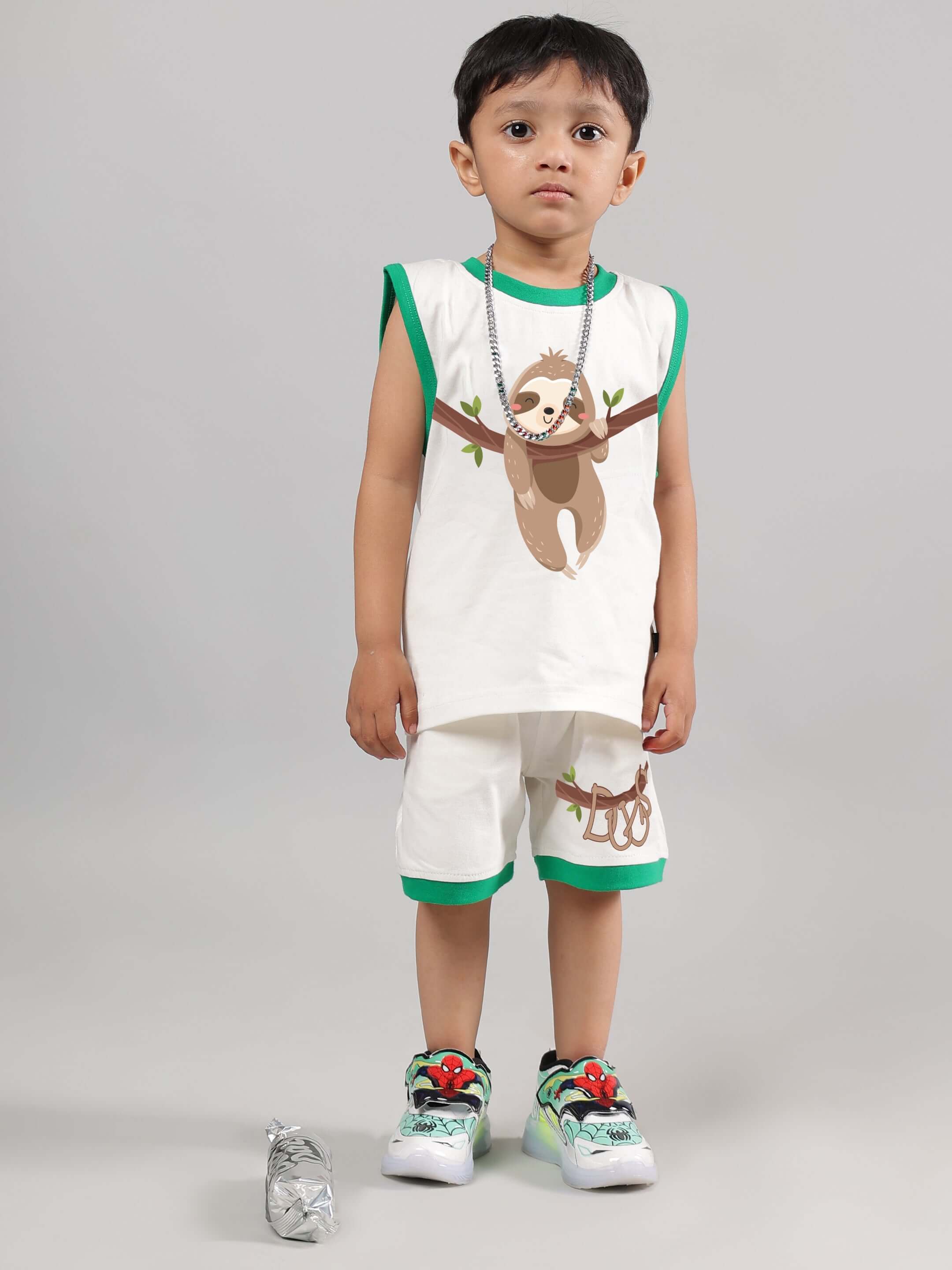 Child wearing off-white sloth-themed co-ord set with green accents, designed for both boys and girls, by DUDS. Comfortable fit, adorable design.