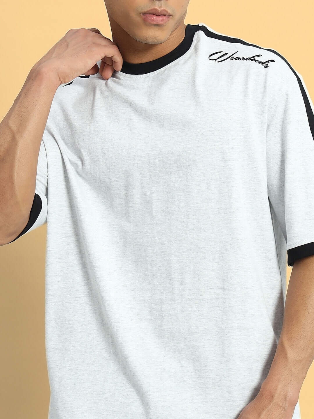 Grey melange over-sized T-shirt made from premium heavy-gauge cotton blend, featuring a relaxed fit and sporty design accents.